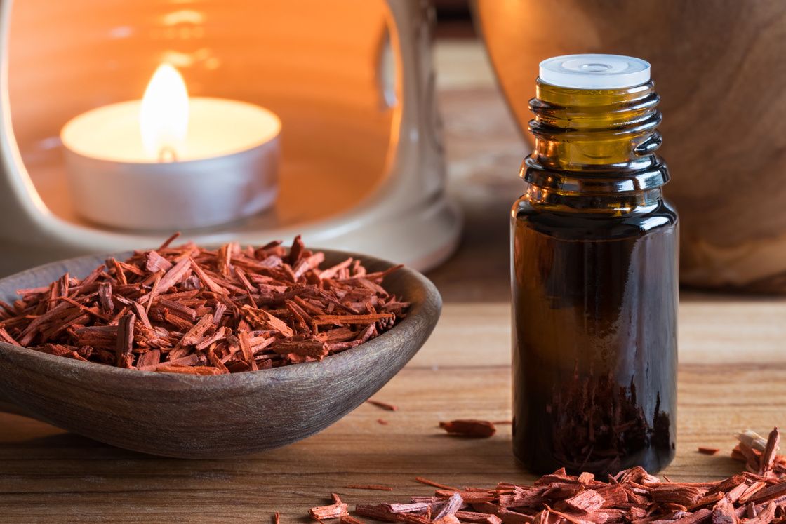 A bottle of sandalwood essential oil with sandalwood